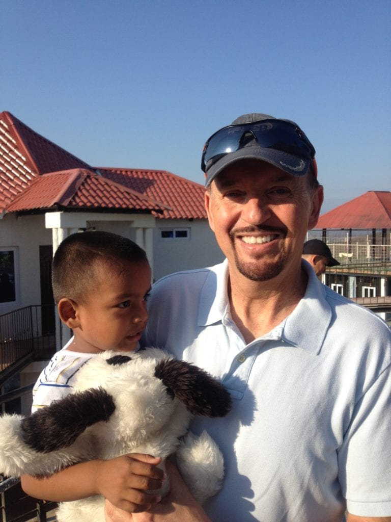 Steve holding young child in Guatemala